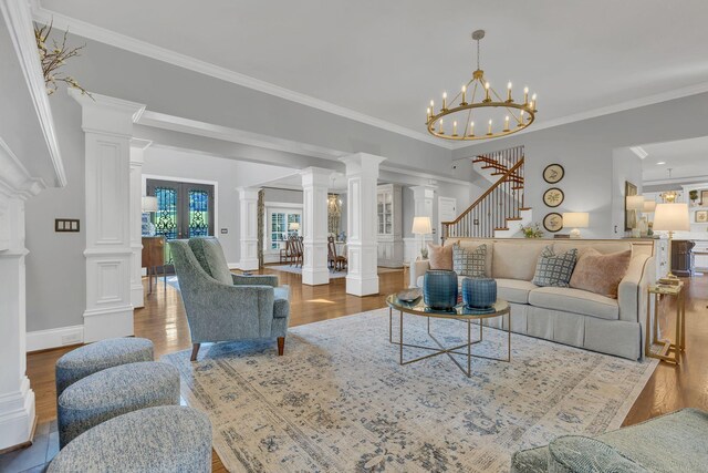3630 Bear Creek Ln, Thompsons Station, TN 37179 - living area featuring wood finished floors, ornamental molding, stairs, french doors, and decorative columns