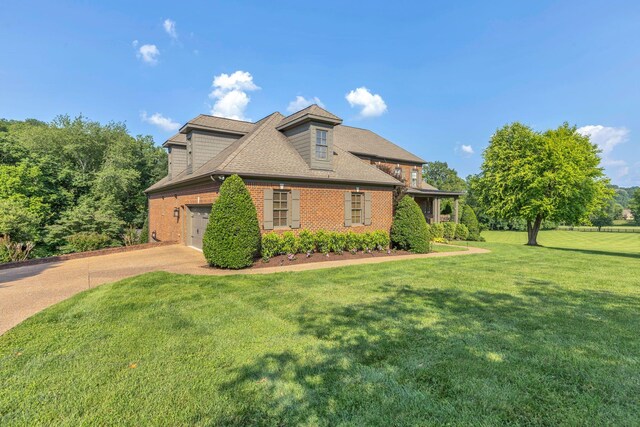 3630 Bear Creek Ln, Thompsons Station, TN 37179 - view of front facade with concrete driveway, brick siding, a front yard, and roof with shingles
