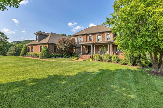 3630 Bear Creek Ln, Thompsons Station, TN 37179 - view of front facade featuring brick siding, covered porch, and a front lawn