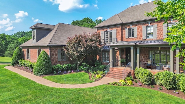 3630 Bear Creek Ln, Thompsons Station, TN 37179 - view of front of house with brick siding, a front lawn, covered porch, and a standing seam roof