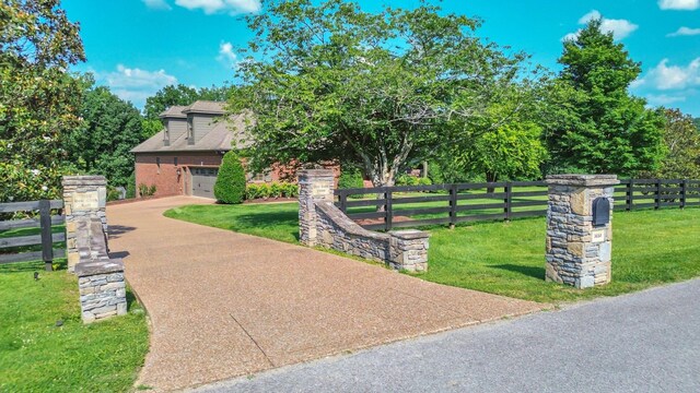 3630 Bear Creek Ln, Thompsons Station, TN 37179 - view of front of home with concrete driveway, brick siding, roof with shingles, and a garage