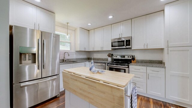 2432 Ponderosa Way, Antioch, TN 37013 - kitchen featuring appliances with stainless steel finishes, a sink, dark wood-style flooring, white cabinets, and recessed lighting