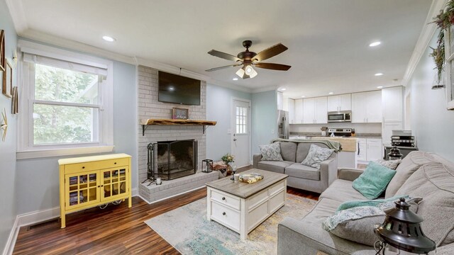 2432 Ponderosa Way, Antioch, TN 37013 - living area featuring crown molding, ceiling fan, wood finished floors, a fireplace, and baseboards