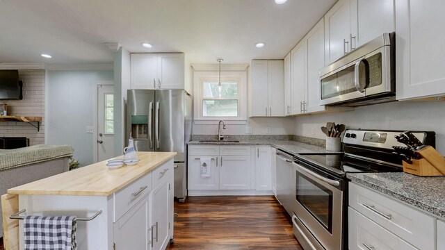 2432 Ponderosa Way, Antioch, TN 37013 - kitchen with appliances with stainless steel finishes, a sink, butcher block counters, recessed lighting, and white cabinetry
