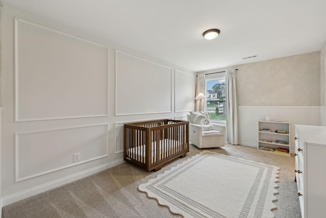 1705 Merkel Rd, Columbia, TN 38401 - bedroom featuring a decorative wall, carpet flooring, a nursery area, and a wainscoted wall