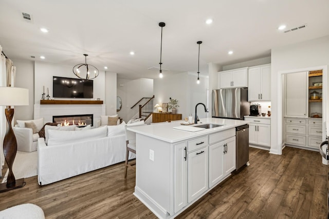 1705 Merkel Rd, Columbia, TN 38401 - kitchen with stainless steel appliances, a sink, open floor plan, dark wood-style flooring, and white cabinets
