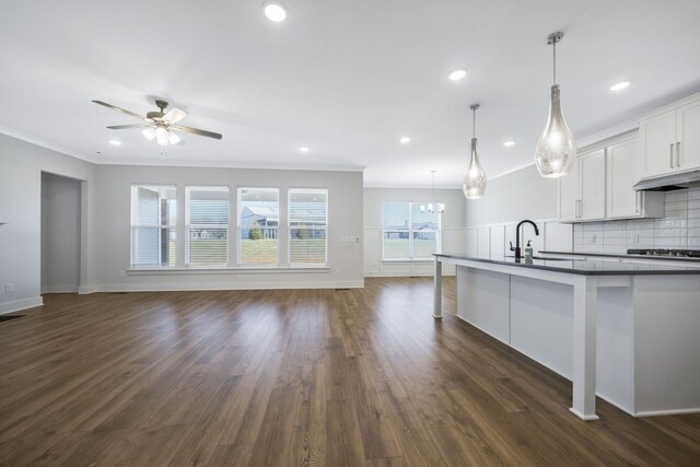 7209 Richvale Dr, Fairview, TN 37062 - kitchen featuring open floor plan, a sink, ornamental molding, dark countertops, and tasteful backsplash