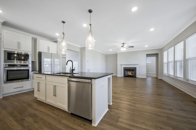 7209 Richvale Dr, Fairview, TN 37062 - kitchen featuring stainless steel appliances, a sink, crown molding, dark countertops, and ceiling fan
