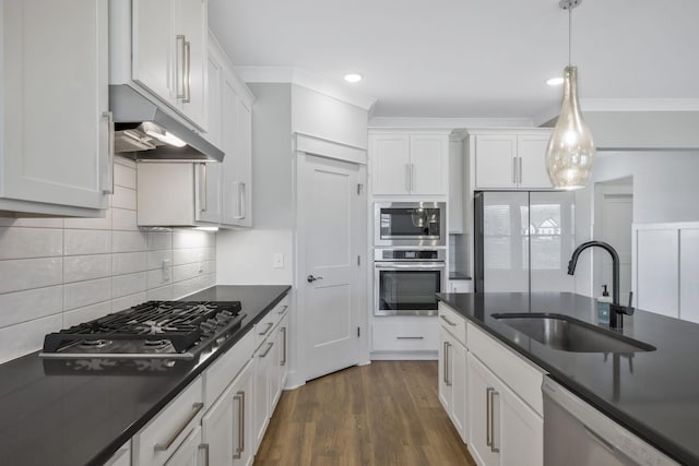 7209 Richvale Dr, Fairview, TN 37062 - kitchen featuring stainless steel appliances, a sink, dark countertops, white cabinets, and decorative backsplash