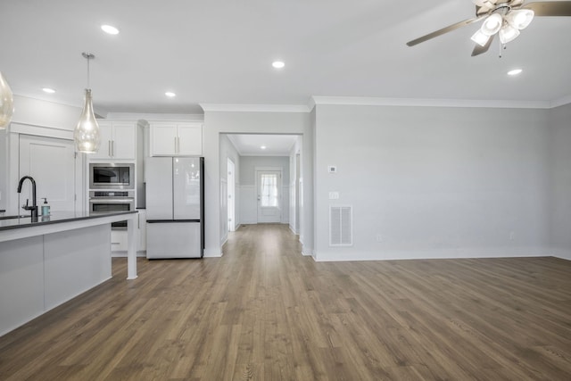 7209 Richvale Dr, Fairview, TN 37062 - kitchen with stainless steel appliances, ornamental molding, wood finished floors, dark countertops, and white cabinets