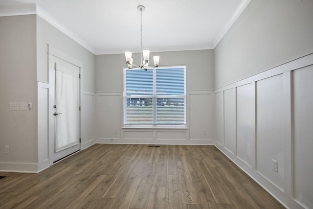 7209 Richvale Dr, Fairview, TN 37062 - unfurnished dining area featuring a decorative wall, a chandelier, wood finished floors, crown molding, and a wainscoted wall