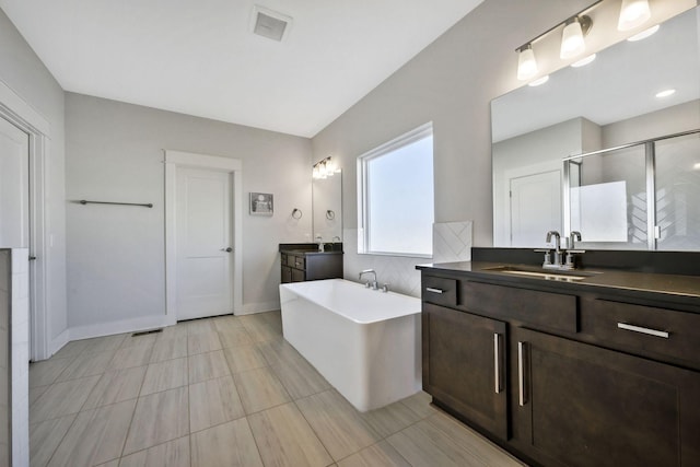 7209 Richvale Dr, Fairview, TN 37062 - full bathroom with a freestanding tub, two vanities, a shower stall, and baseboards