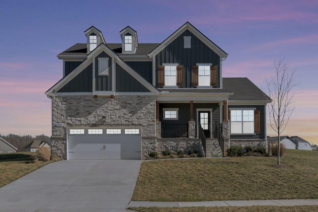 7209 Richvale Dr, Fairview, TN 37062 - view of front facade featuring board and batten siding, a garage, concrete driveway, stone siding, and a yard