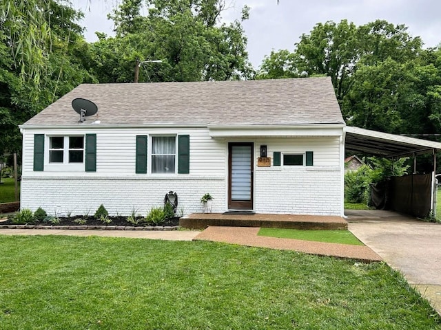 910 Virginia Ave, Nashville, TN 37216 - view of front of home with concrete driveway, a front yard, a carport, a shingled roof, and brick siding