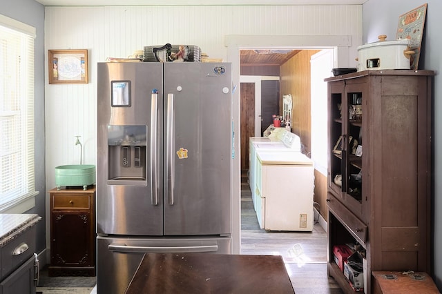 3281 Pulaski Hwy, Lawrenceburg, TN 38464 - kitchen featuring stainless steel fridge with ice dispenser, independent washer and dryer, wood finished floors, and wood walls