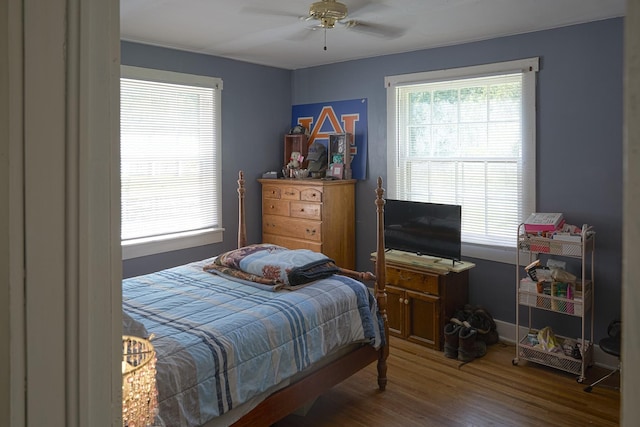 3281 Pulaski Hwy, Lawrenceburg, TN 38464 - bedroom featuring multiple windows, wood finished floors, and a ceiling fan