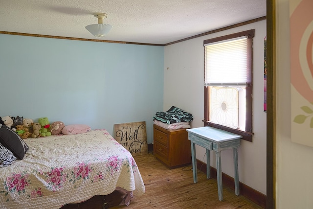 3281 Pulaski Hwy, Lawrenceburg, TN 38464 - bedroom featuring wood finished floors, a textured ceiling, and crown molding