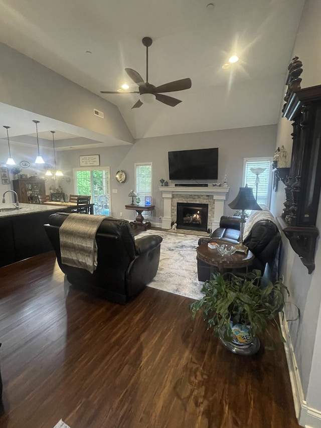 380 Preakness Cir, Pleasant View, TN 37146 - living area with dark wood-style floors, a ceiling fan, lofted ceiling, and a stone fireplace