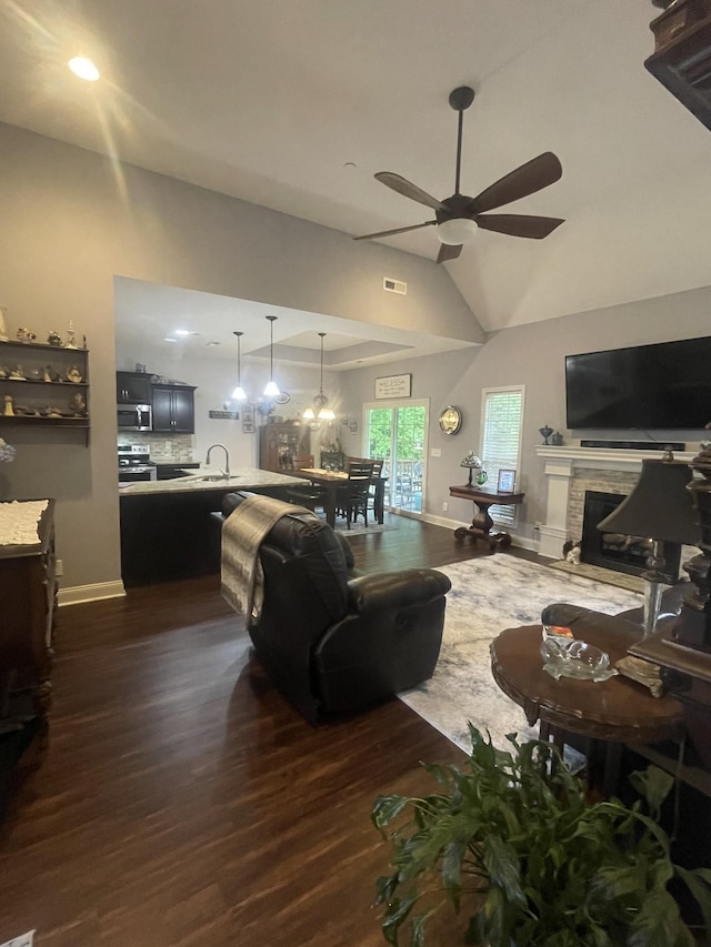 380 Preakness Cir, Pleasant View, TN 37146 - living area with a ceiling fan, dark wood-style flooring, a fireplace, vaulted ceiling, and baseboards