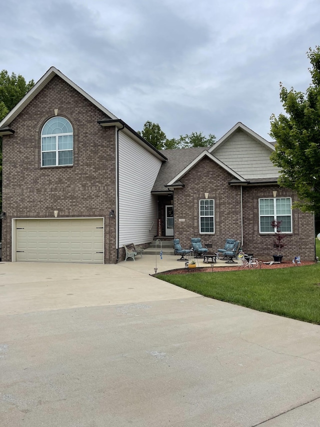 380 Preakness Cir, Pleasant View, TN 37146 - view of front of property featuring a garage, brick siding, driveway, and a front lawn