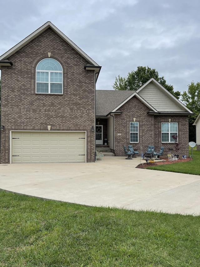 380 Preakness Cir, Pleasant View, TN 37146 - view of front of home featuring an attached garage, driveway, brick siding, and a front lawn