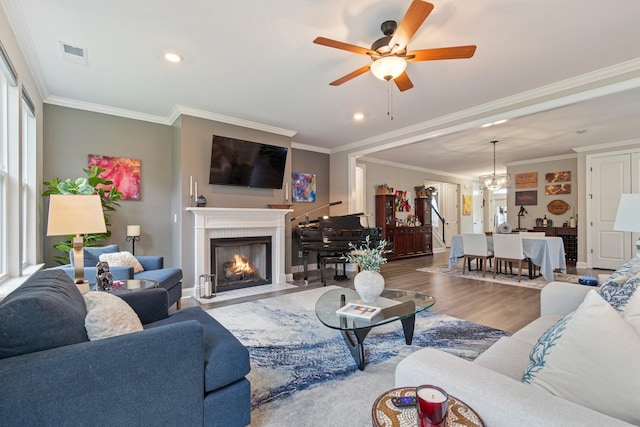 1336 Von Hallen Ct, Murfreesboro, TN 37128 - living area featuring ornamental molding, a ceiling fan, wood finished floors, a fireplace with flush hearth, and a chandelier