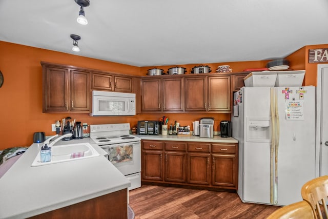 2751 Jarrell Ridge Rd, Clarksville, TN 37043 - kitchen with white appliances, light countertops, dark wood-style floors, and brown cabinetry