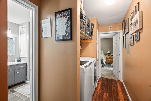 2751 Jarrell Ridge Rd, Clarksville, TN 37043 - laundry room with washing machine and dryer, dark wood-style flooring, and baseboards