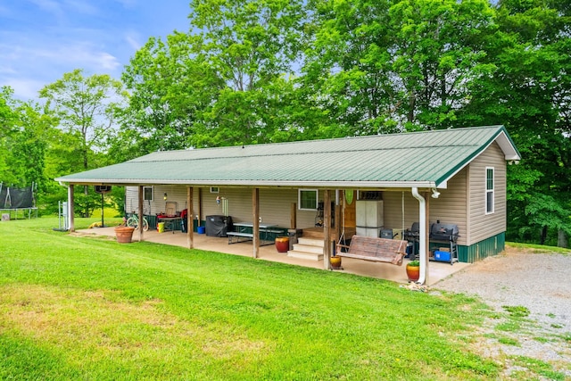 2751 Jarrell Ridge Rd, Clarksville, TN 37043 - view of front facade featuring a trampoline, a front yard, a patio, and metal roof