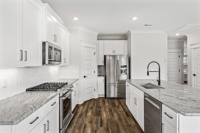 528 Kingwood Ln, White House, TN 37188 - kitchen with appliances with stainless steel finishes, a sink, crown molding, dark wood-style flooring, and white cabinetry
