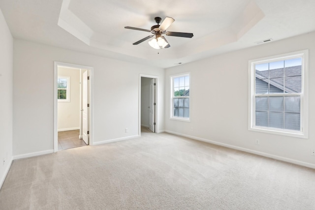 2889 Sharpie Dr, Clarksville, TN 37040 - unfurnished bedroom featuring a tray ceiling, light carpet, baseboards, and ensuite bathroom