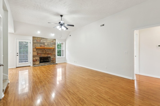 2889 Sharpie Dr, Clarksville, TN 37040 - unfurnished living room with a ceiling fan, vaulted ceiling, light wood-style floors, a stone fireplace, and baseboards