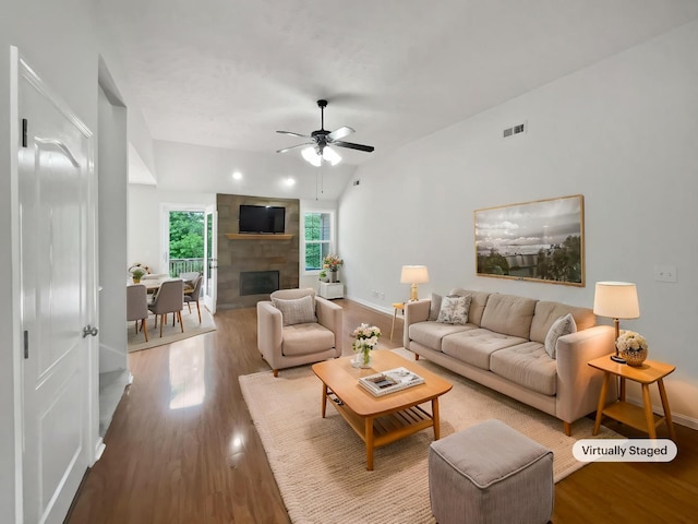 2889 Sharpie Dr, Clarksville, TN 37040 - living area featuring wood finished floors, a large fireplace, ceiling fan, and baseboards