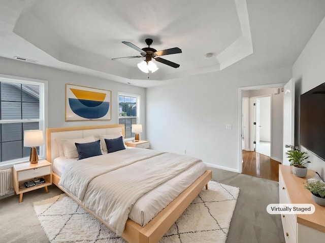 2889 Sharpie Dr, Clarksville, TN 37040 - carpeted bedroom with a tray ceiling, a ceiling fan, and baseboards