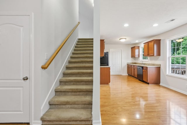 2889 Sharpie Dr, Clarksville, TN 37040 - stairs with wood finished floors, recessed lighting, and baseboards