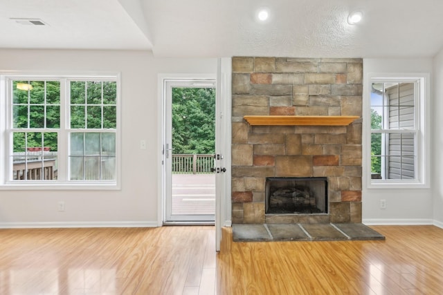 2889 Sharpie Dr, Clarksville, TN 37040 - unfurnished living room with wood finished floors, baseboards, and a stone fireplace