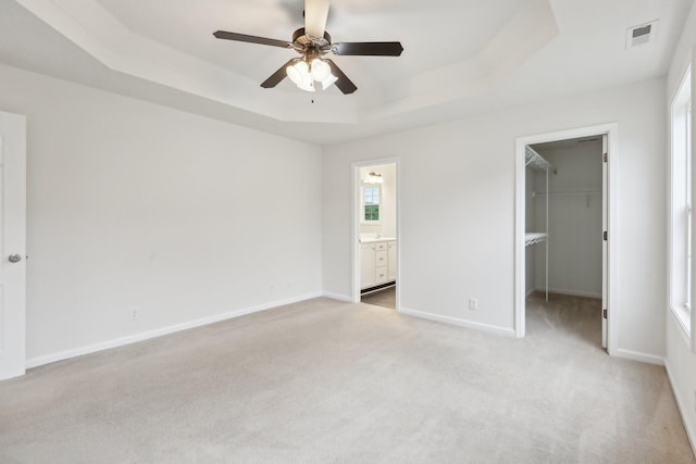 2889 Sharpie Dr, Clarksville, TN 37040 - unfurnished bedroom with a tray ceiling, light colored carpet, a spacious closet, and ensuite bath