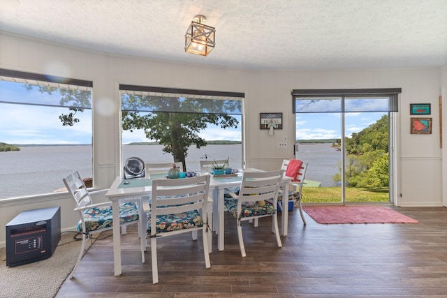440 Bluff Point Ln, Waverly, TN 37185 - dining room featuring a textured ceiling, wood finished floors, and a water view