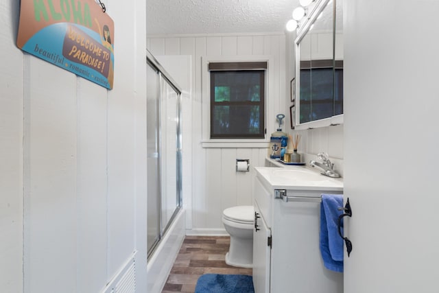 440 Bluff Point Ln, Waverly, TN 37185 - full bathroom with toilet, vanity, a textured ceiling, wood finished floors, and enclosed tub / shower combo