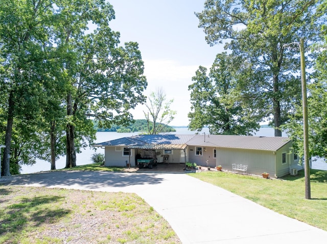 440 Bluff Point Ln, Waverly, TN 37185 - ranch-style house featuring concrete driveway, metal roof, a front lawn, and a carport