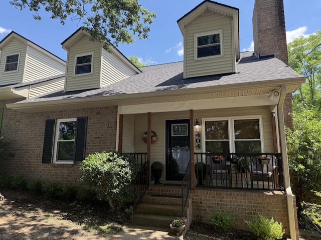 404 Hill Rd, Nashville, TN 37220 - view of front of house featuring a chimney, a shingled roof, brick siding, and a porch