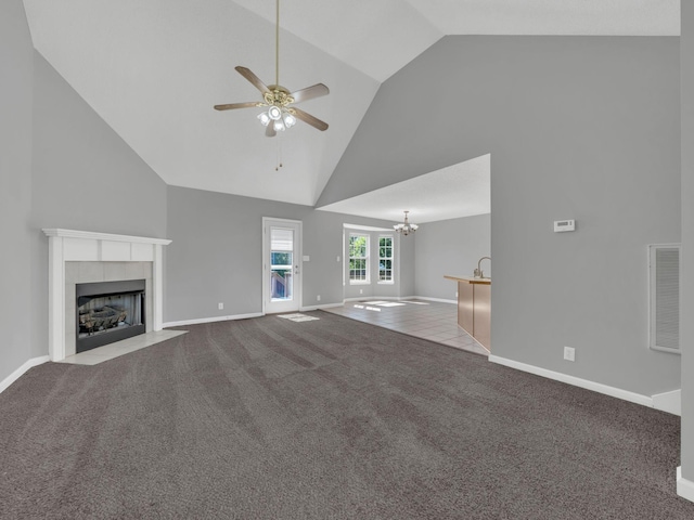 3825 Roscommon Way, Clarksville, TN 37040 - unfurnished living room with a ceiling fan, high vaulted ceiling, a tiled fireplace, carpet floors, and a chandelier