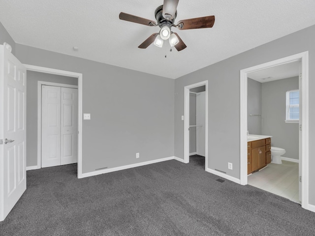 3825 Roscommon Way, Clarksville, TN 37040 - unfurnished bedroom featuring dark colored carpet, baseboards, connected bathroom, a ceiling fan, and a closet