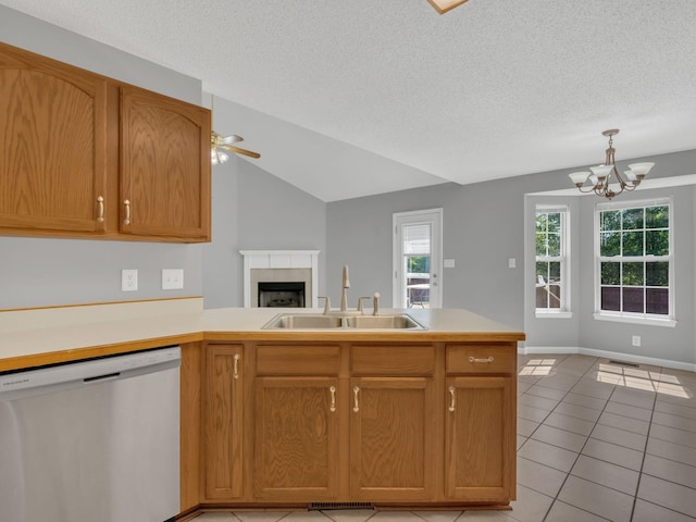 3825 Roscommon Way, Clarksville, TN 37040 - kitchen with stainless steel dishwasher, a sink, a fireplace, a peninsula, and light tile patterned floors