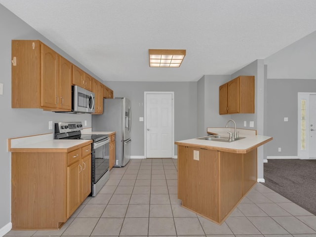 3825 Roscommon Way, Clarksville, TN 37040 - kitchen featuring appliances with stainless steel finishes, a sink, a peninsula, light tile patterned floors, and light countertops
