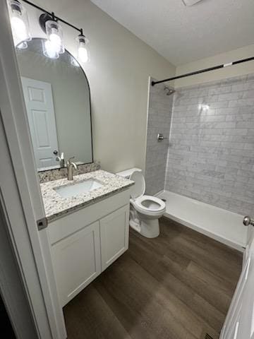803 17th Ave E, Springfield, TN 37172 - full bathroom featuring toilet, vanity, tiled shower, and wood finished floors