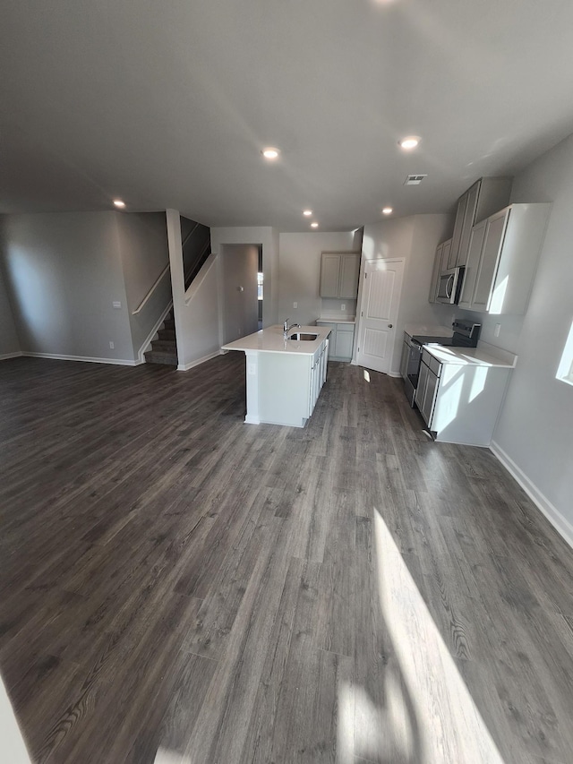 713 Walleye Way, Antioch, TN 37013 - kitchen featuring electric range, stainless steel microwave, open floor plan, dark wood-style flooring, and a sink