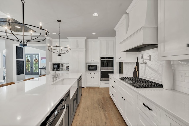 4480 Old Murfreesboro Rd W, Lebanon, TN 37090 - kitchen with stainless steel appliances, custom exhaust hood, light countertops, white cabinets, and recessed lighting