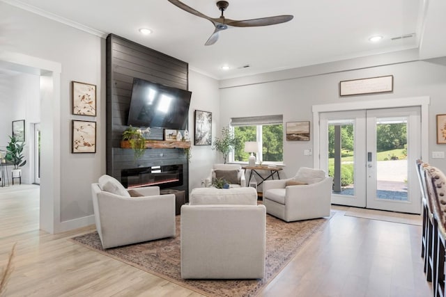 2878 Fly Rd, Santa Fe, TN 38482 - living area featuring ornamental molding, light wood-type flooring, ceiling fan, a large fireplace, and french doors