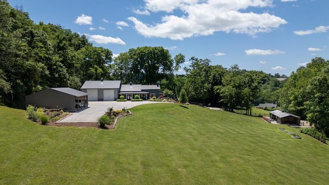 2878 Fly Rd, Santa Fe, TN 38482 - view of grassy yard featuring a detached garage and driveway